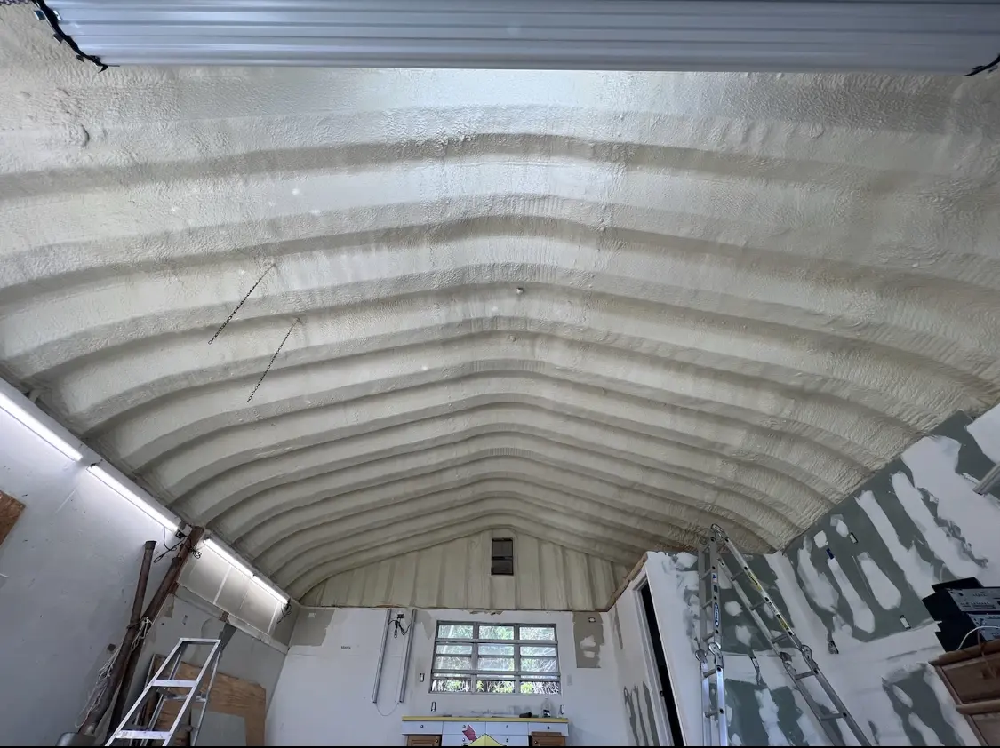 Spray polyurethane foam applied to the underside of a metal roof deck in Hereford